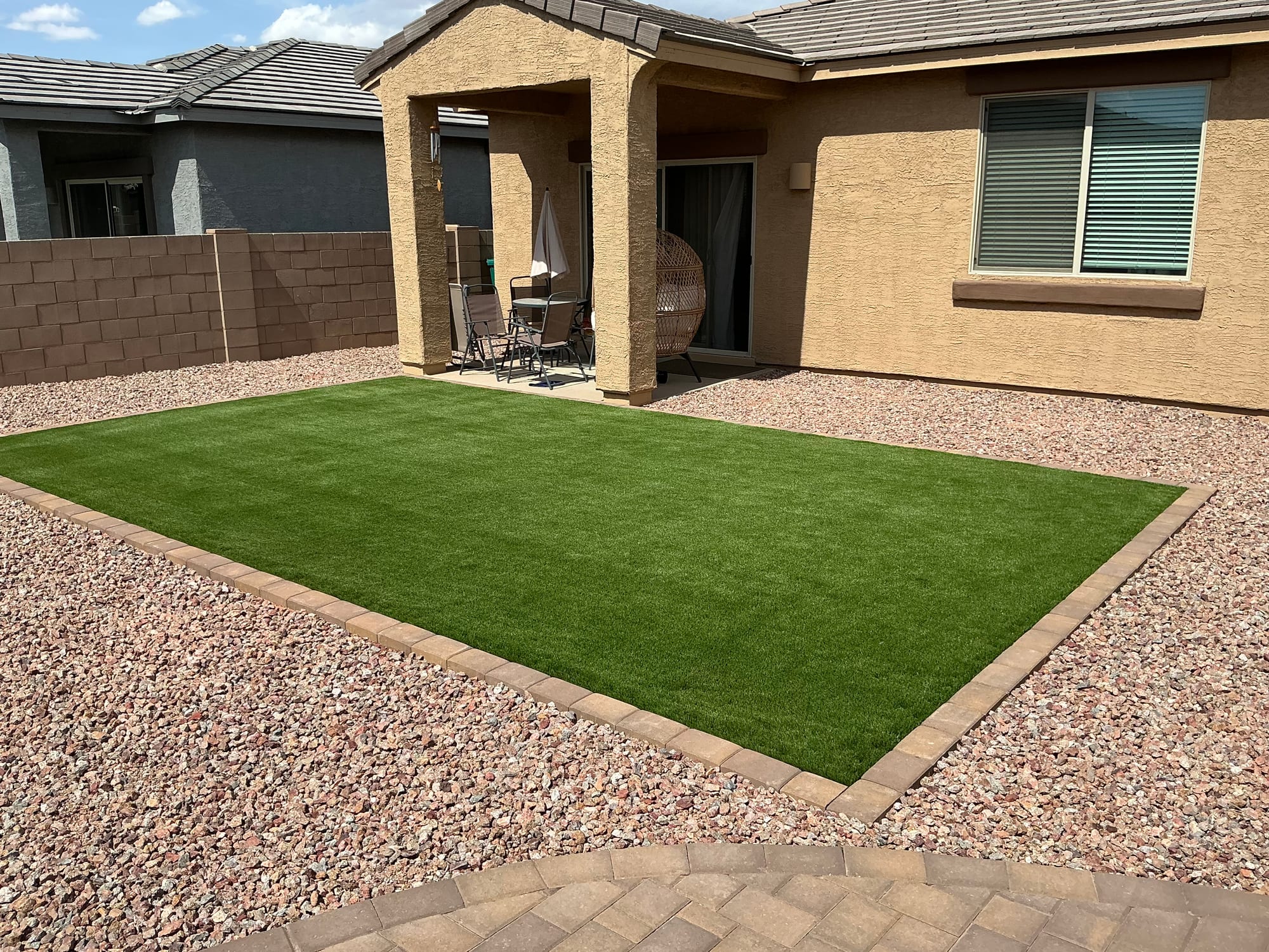 Water-wise xeriscape backyard with decomposed granite and desert plantings in Rita Ranch by Sorce Signature Outdoors