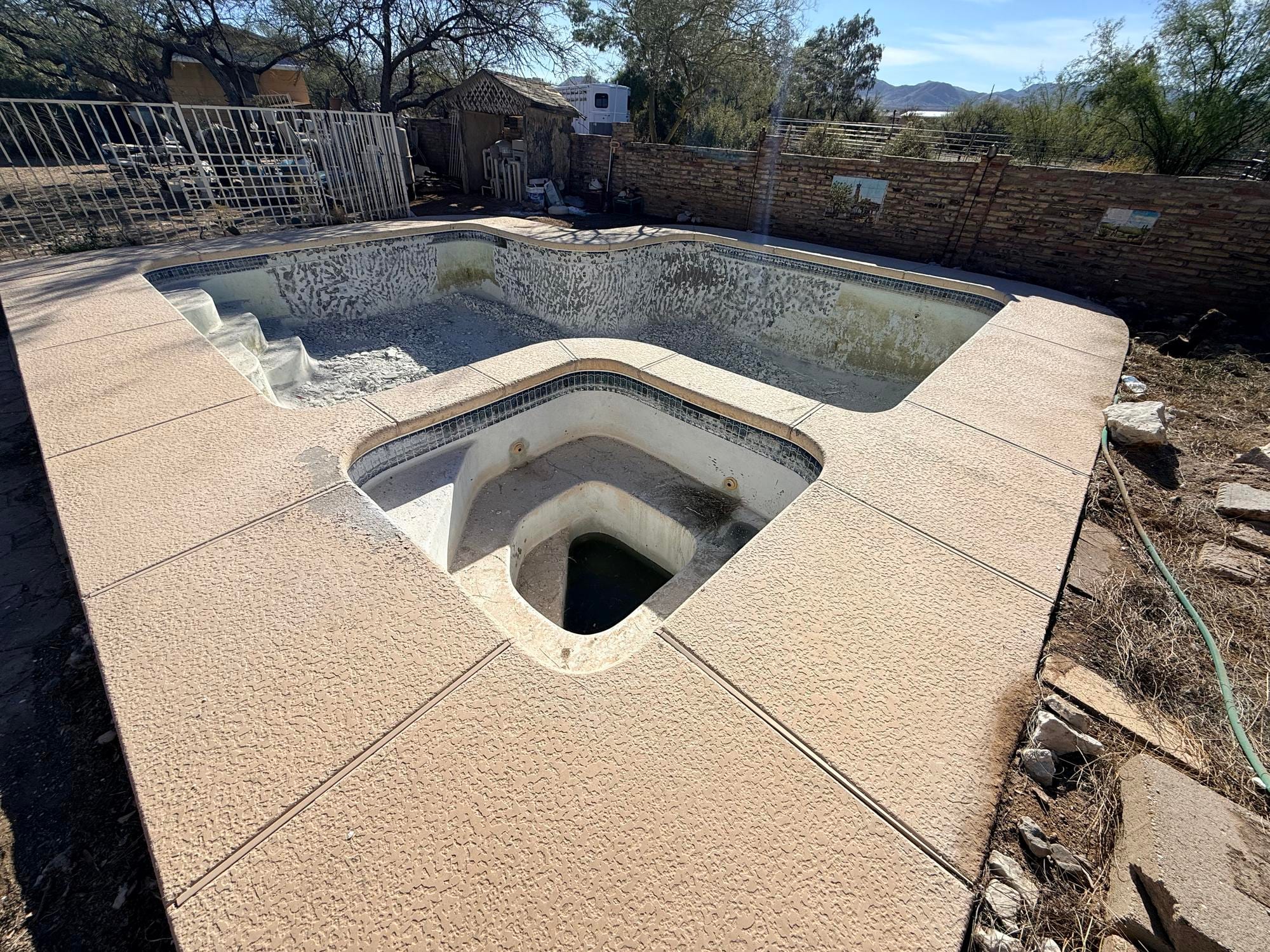 Before: abandoned concrete pool with spa