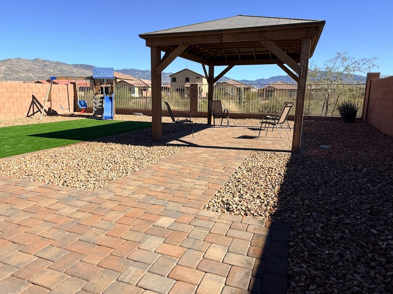 Wood ramada shade structure over a paver patio and turf in a Tucson backyard by Sorce Signature Outdoors